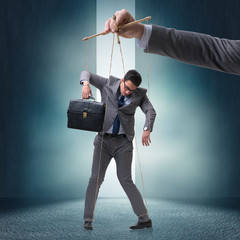Businessman puppet being manipulated by boss