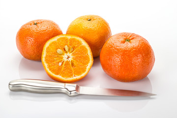 Fresh orange and knife isolated on white background