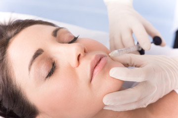 Closeup of beautiful woman receiving hyaluronic acid treatment.