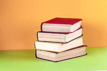 Old books on a wooden shelf. No labels, blank spine.