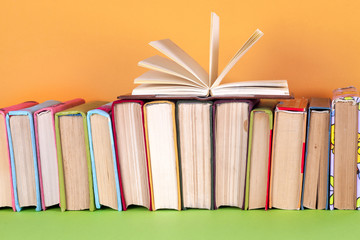 Open book, hardback bookson bright colorful background.