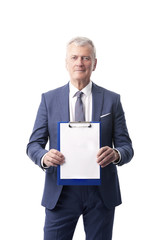 Man with clipboard. Shot of a senior sales man in his hand a clipboard with a blank paper while...