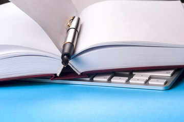Office black desk table with white computer, business card blank, flower, coffee cup and pen.
