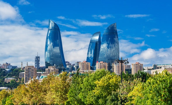 Flame towers in Baku cityscape.