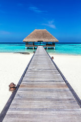 Wooden jetty leading to relaxation lodge. Maldives islands