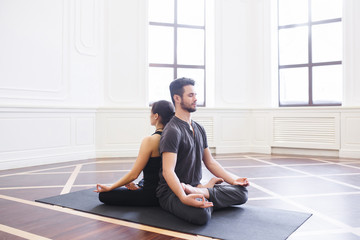 Young couple meditating together