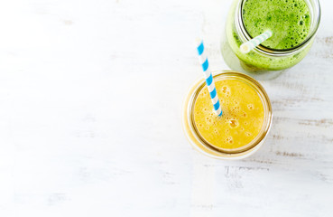 Banana-orange and banana-kale smoothie in glasses

