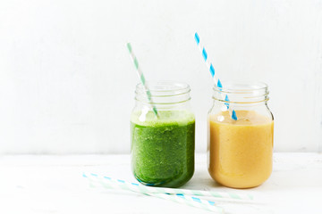 Banana-orange and banana-kale smoothie in glasses

