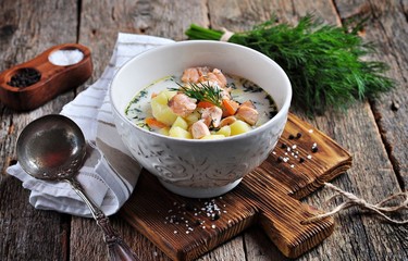 Creamy soup with wild salmon, potatoes, carrots and dill. Healthy food.