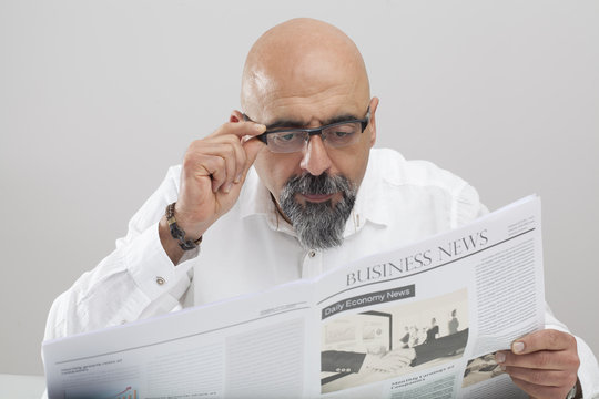 Middle aged man reading newspaper