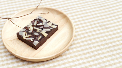 Chocolate Brownie on wooden plate 