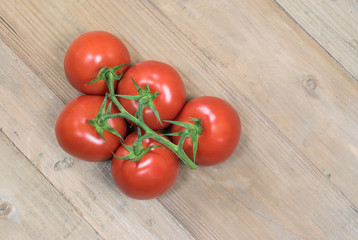 Fresh tomatoes on wooden background.