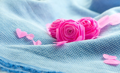 Pink rose and small hart on blue cloth background for Valentine