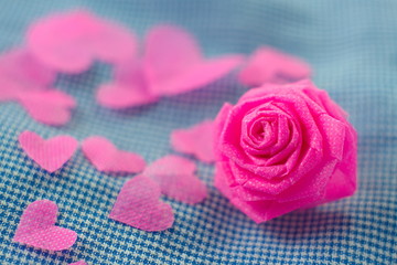 Pink rose and small hart on blue cloth background for Valentine