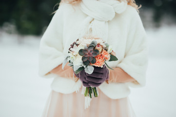 bride with a bouquet on the winter background