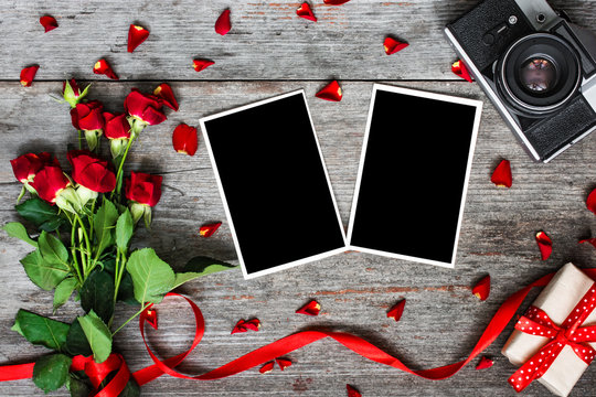 blank photo frames, vintage retro camera and red roses flowers