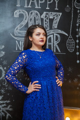 cute brown-haired woman in a blue evening dress lace