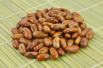 Brown pinto beans on bamboo mat
