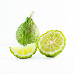 Fototapeta na wymiar Green rough peel bergamot fruit or kaffir lime isolated on white
