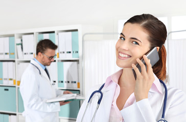 Doctor smiling on the phone, concept of medical booking
