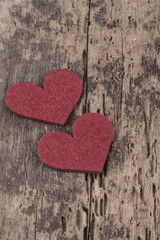 Small red hearts on wooden surface