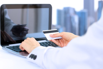 Obraz na płótnie Canvas Business woman entering data of a credit card . On-line shopp