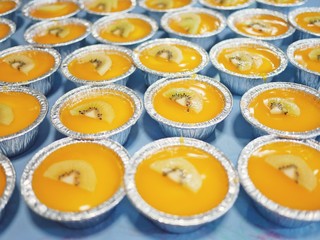 Many cups of orange cake.