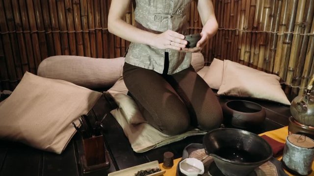 tea bowl in the hands of the guest.Tea ceremony. Brewing tea in the style of the Tang dynasty. A staged ceremony of brewing Chinese tea the original method. 
