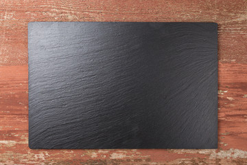 slate board on wooden background