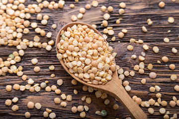 peas in a wooden spoon