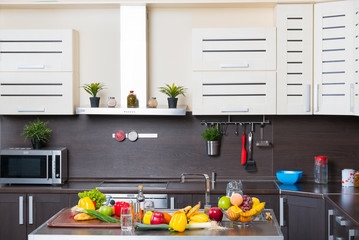 Interior of modern kitchen with fruits and vegetables on the table