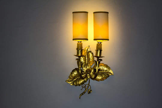 Old wall lamp made of metal with shade from canvas