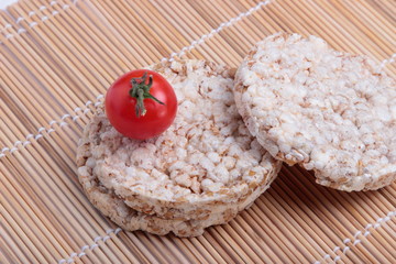 crispbread and cherry tomatoes on a bamboo Mat