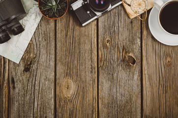 Accessories for travel top view on wooden background with copy space. Adventure and wanderlust concept image with travel accessories. Preparing for an exotic trip, journey and sightseeing.