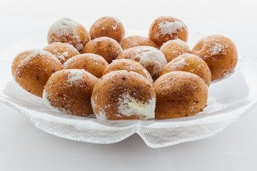 Round doughnuts dusted with powdered sugar
