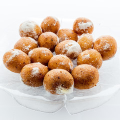 Round doughnuts dusted with powdered sugar