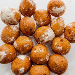 Round doughnuts dusted with powdered sugar