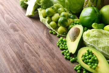 Green vegetables on wooden background