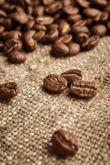 Fototapeta premium Coffee beans on vintage fabric