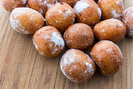 Round doughnuts dusted with powdered sugar