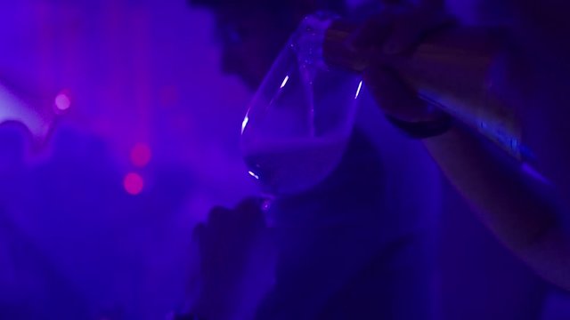the girl pours alcohol
