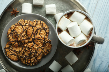 Cup of hot cocoa with marshmallows on tray