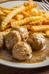 Meatballs with french fries in dill sauce.