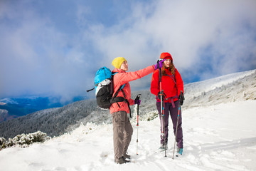 Two girls in the mountains in winter.