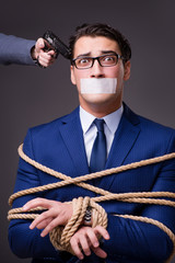 Businessman taken hostage and tied up with rope