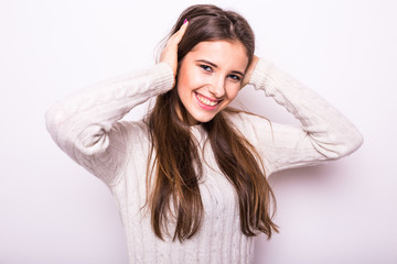 Portrait of young fashion girl in white sweater on white