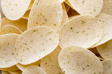 Close up potato chips on wood top view background.