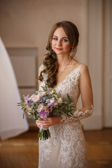 Wedding bride, portrait of beautiful bride with bouquet of flowers in rustic style