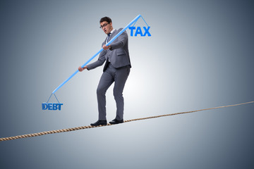 Businessman balancing between debt and tax