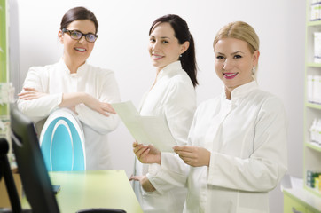 Group of young, beautiful female pharmacists, selective focus on blonde woman 